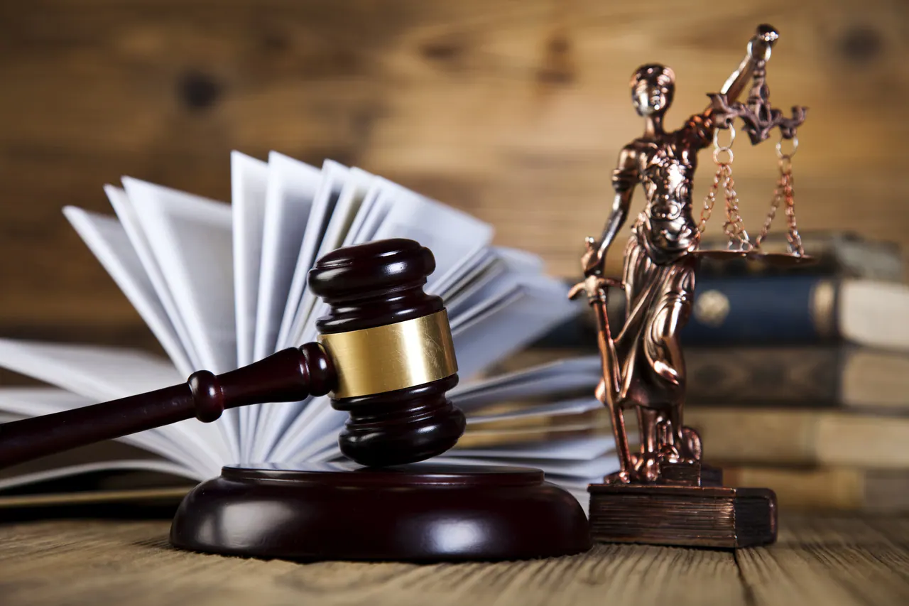 Judge’s gavel, law books, and a Lady Justice statuette