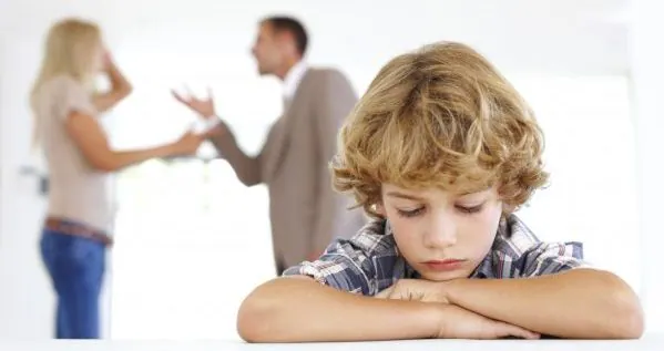 Child in the foreground while two adults argue