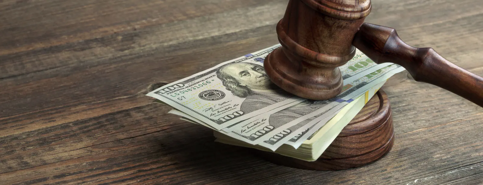 Judge’s gavel resting on U.S. currency