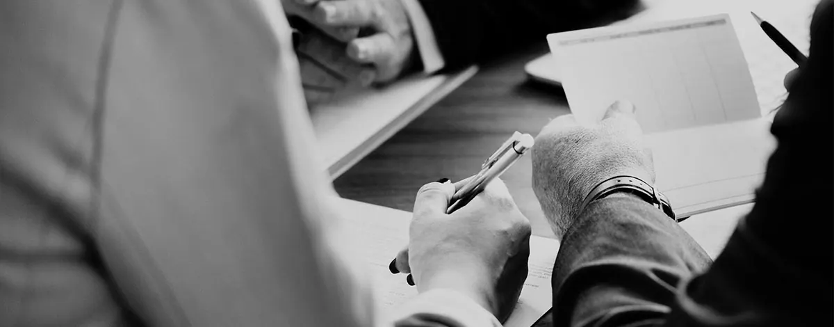 Close-up of a person signing a document