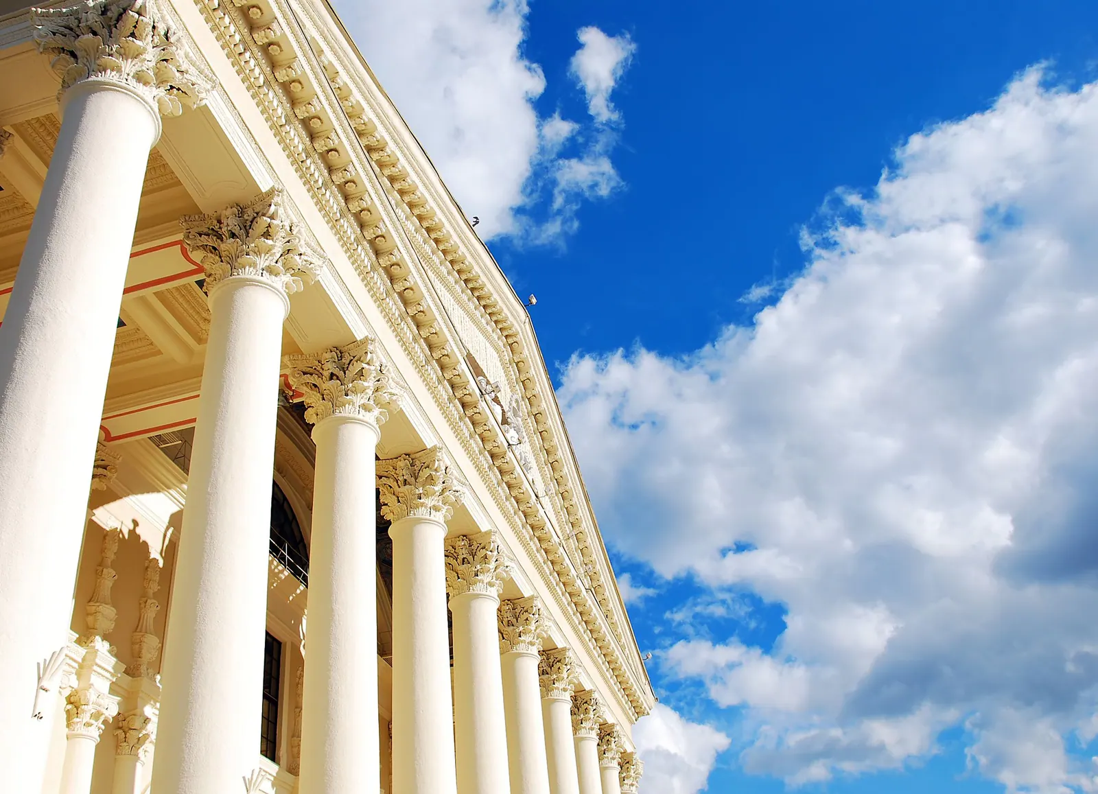 Courthouse columns beneath a blue sky
