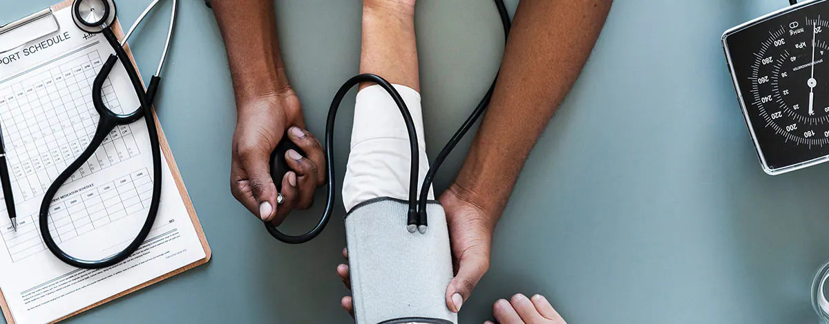 Doctor speaking with a patient while holding their hands