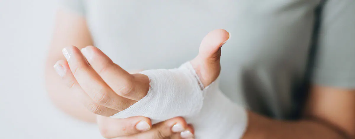 Person holding an injured wrist