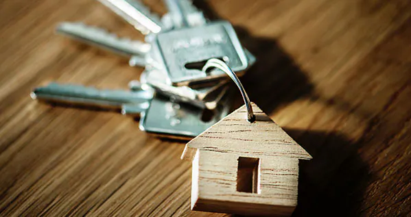 House key with a house-shaped keychain