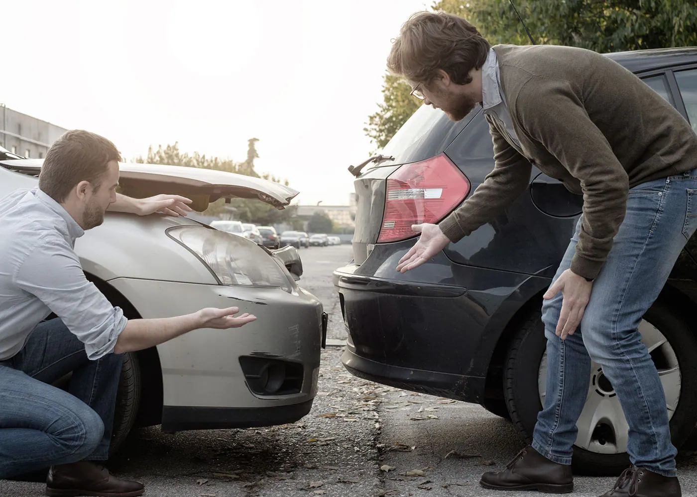 Drivers inspecting damage after a collision